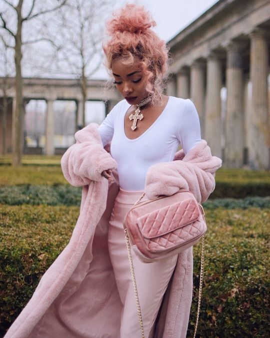 pastel pink curly hair in a top knot, with some locks down is a lovely idea and it finishes off the pink look