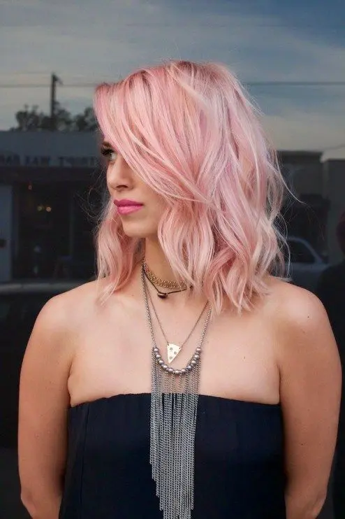 shoulder-length pastel pink hair with much texture and waves is a girlish and chic idea, it's a trendy color