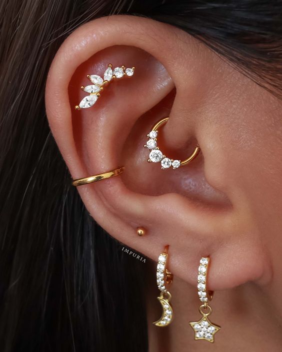 stacked and high lobe, daith, conch and flat piercings done with hoops and a stud look very chic and bold