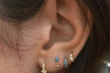 stacked lobe and high lobe piercings with gold rhinestone and blue rhinestone hoops and studs look awesome