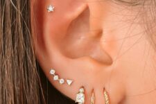 stacked lobe, high lobe and a flat piercing done with hoops and catchy studs look very chic