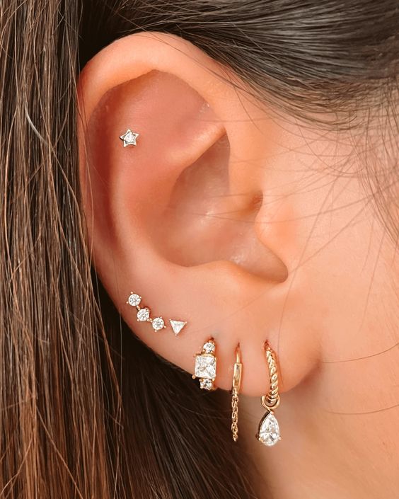 stacked lobe, high lobe and a flat piercing done with hoops and catchy studs look very chic
