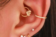 stacked lobe, high lobe, conch, daith and flat piercings accented with gold hoops and studs look very nice
