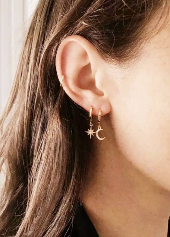 star and moon hoop earrings in a double lobe piercing plus a mid helix piercing done with a gold hoop
