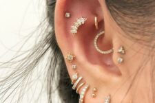 super bold ear styling with a multiple lobe, mid-helix, flat, helix, daith, rook and double tragus piercing with rhinestone hoops and studs