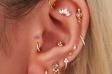 super chic and bold ear styling with multiple lobe, mid-helix, helix, flat, forward helix, conch and double tragus piercing with colorful rhinestone studs and hoops
