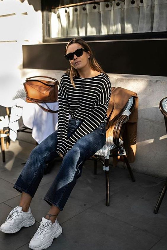 a black Breton stripe top, navy jeans, white trainers and a brown bag for a warm spring day