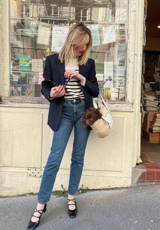 a Breton stripe top, a black blazer, blue jeans, black Mar Jane shoes and a straw bag for spring