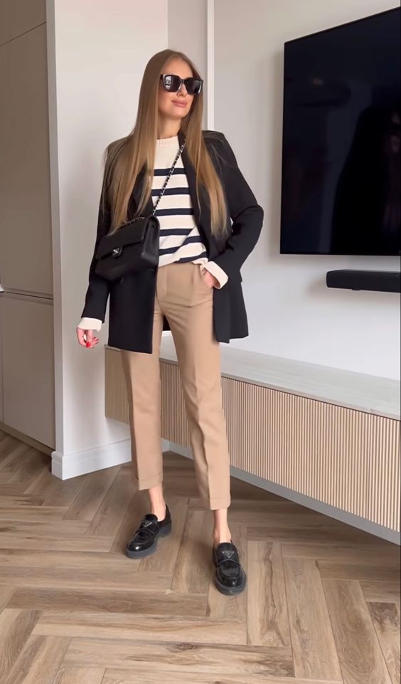 a Breton stripe top, a black oversized blazer, beige pants, black chunky loafers and a black bag for wearing to work