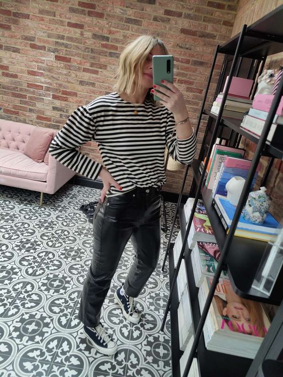 a Breton stripe top, black leather pants, black sneakers are a cool look that is basic but bold