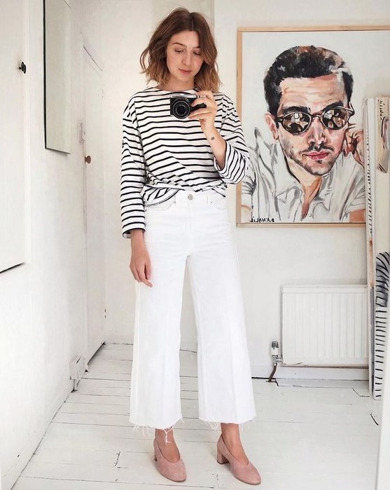 a Breton stripe top, white flare jeans, blush heels for a refined and stylish outfit with a touch of French chic