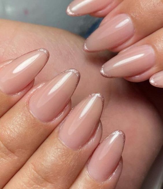 nude almond-shaped nails with rose gold micro tips are a delicate take on a French manicure