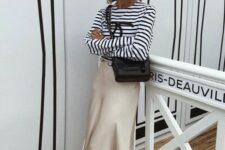 21 a Breton striped top, a champagne-colored midi slip skirt, black slingbacks and a black bag for a girlish look
