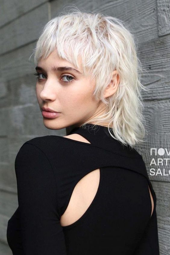 a cool and shaggy icy blonde mullet with fringe and bottleneck bangs is a very chic and cool idea