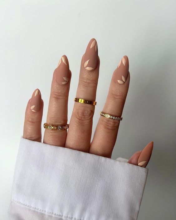 matte nude nails with neutral leafy detailing are a gorgeous idea for wearing right now