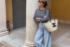 22 a navy and white Breton stripe top, blue wideleg jeans, white sneakers, a straw bag are a lovely combo for a weekend