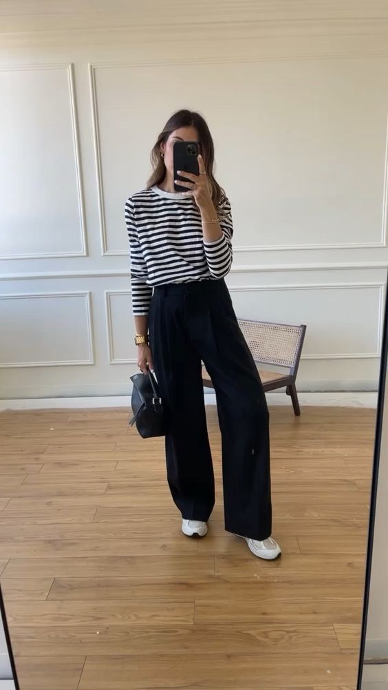 a simple and classy look with a Breton strip shirt, black pants, neutral trainers and a black bag is cool for work and every day