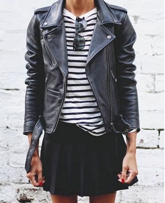 a striped black and white top, a black leather jacket, a black pleated mini for a stylish and cool look