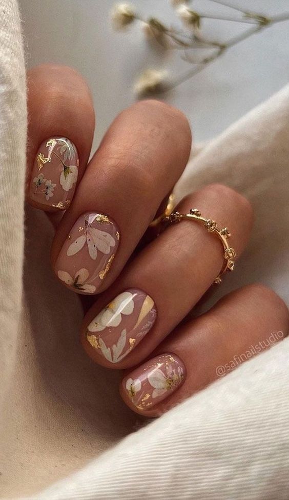 nude nails with wihte flower stickers and gold foil are amazing for rocking them in spring and summer