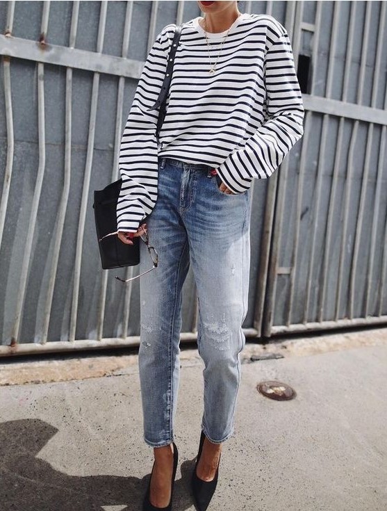 blue boyfriends, a striped black and white top, a necklace and pointed toe heels plus a black bag