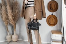 32 a Breton stripe jumper, a beige blazer and pants, black chunky loafers, a black bag are a cool look for work