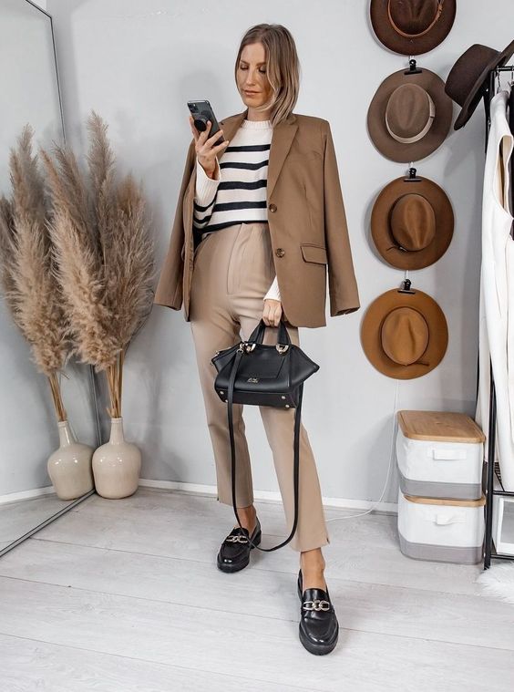 a Breton stripe jumper, a beige blazer and pants, black chunky loafers, a black bag are a cool look for work