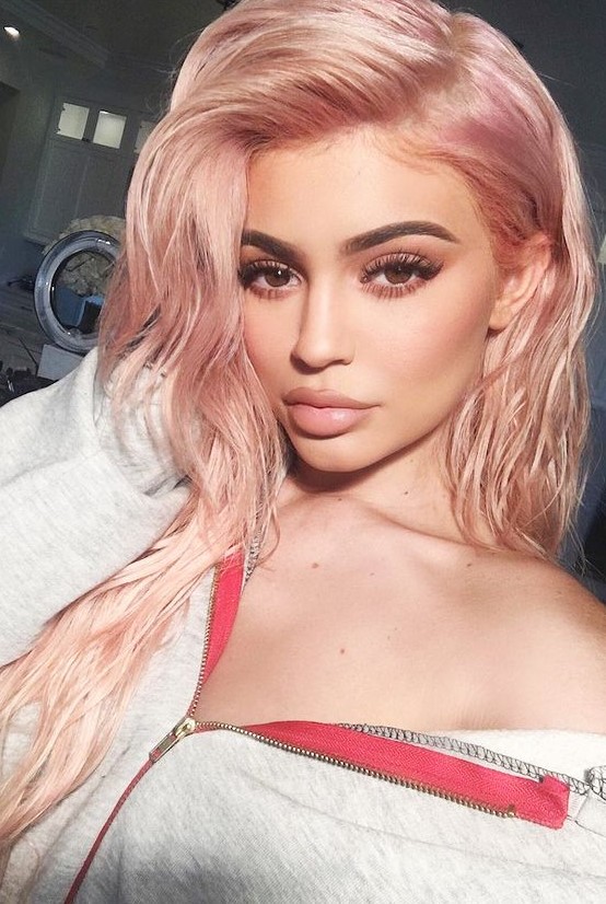 Kylie Jenner wearing long locks with a pretty peachy rose blonde shade looks very girlish
