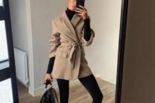 With beige belted coat, black leather bag and black leather mid calf flat boots