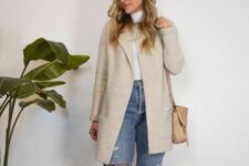 With beige collarless long jacket and beige leather bag