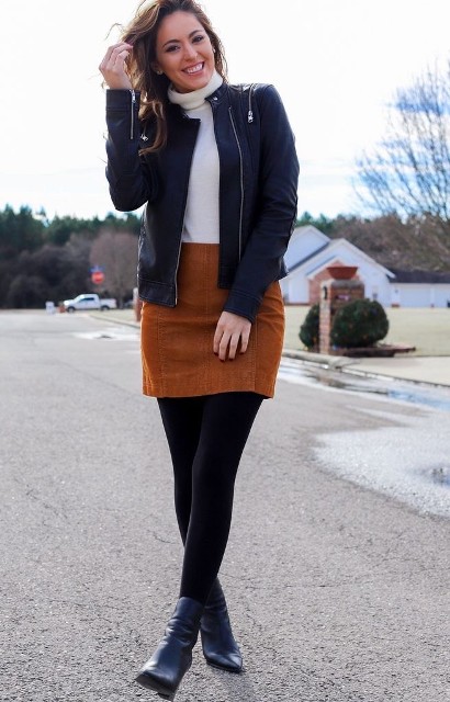 With black leather collarless jacket, black tights and black leather ankle boots