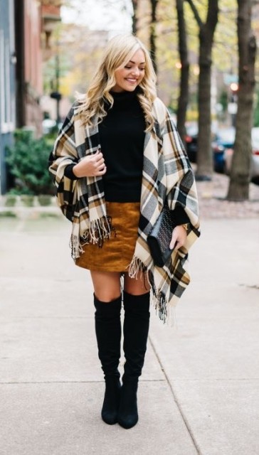 With brown, gray and white plaid scarf with a fringe, black leather embellished clutch and black suede over the knee boots