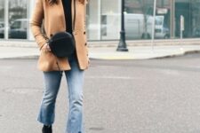 With brown jacket, black leather rounded bag and black suede mid calf heeled boots