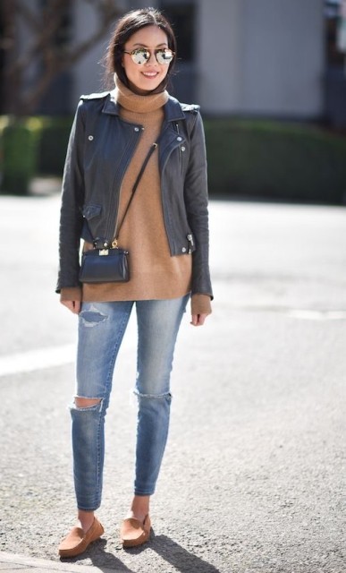 With mirrored rounded sunglasses, black leather crop jacket, black leather crossbody mini bag and beige suede flat shoes