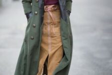 With oversized sunglasses, olive green maxi coat and gray suede lace up ankle boots