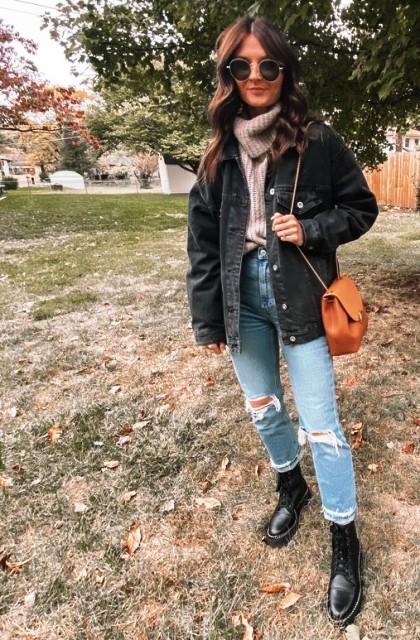With rounded sunglasses, black denim loose jacket, brown leather chain strap bag and black leather lace up mid calf boots
