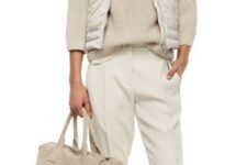 With silver necklace, white puffer vest and beige big bag