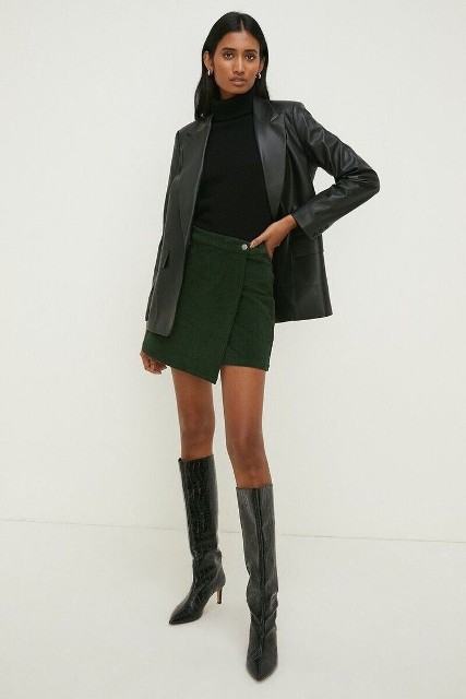 With silver rounded earrings, black leather long blazer and black leather high boots