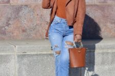 With silver rounded earrings, brown leather bag, brown suede jacket and brown suede pumps