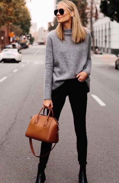 With sunglasses, brown leather bag and black leather heeled ankle boots
