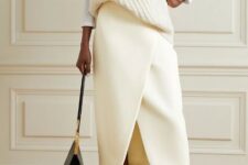 With white knitted loose vest, black leather bag and black patent leather flat shoes