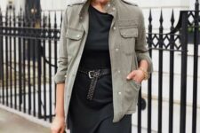 a black midi dress with an accent belt, a grey utility jacket and a black bag are a stylish and simple combo