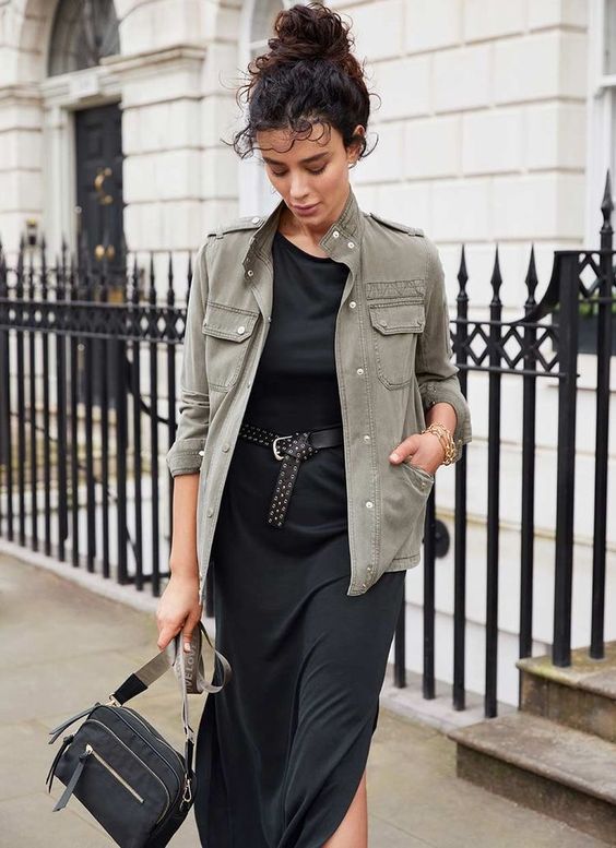 a black midi dress with an accent belt, a grey utility jacket and a black bag are a stylish and simple combo