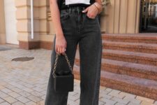 a black printed t-shirt, black wideleg jeans, neutral heels, a black bag with chain and gold earrings