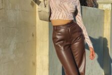 a blush printed top, brown leather pants, strappy heels and a small neutral bag are a nice party look