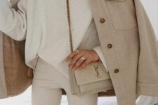 a cremay turtleneck and leather pants, a greige shirt jacket, a tan bag are a super elegant look