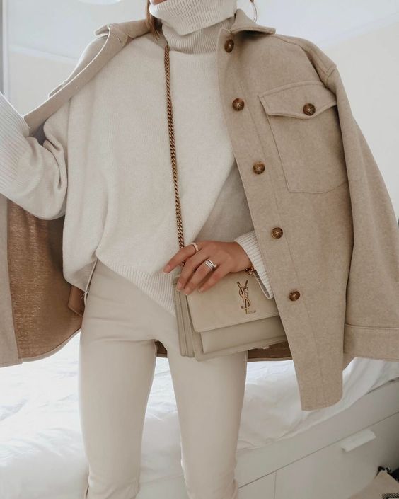 a cremay turtleneck and leather pants, a greige shirt jacket, a tan bag are a super elegant look