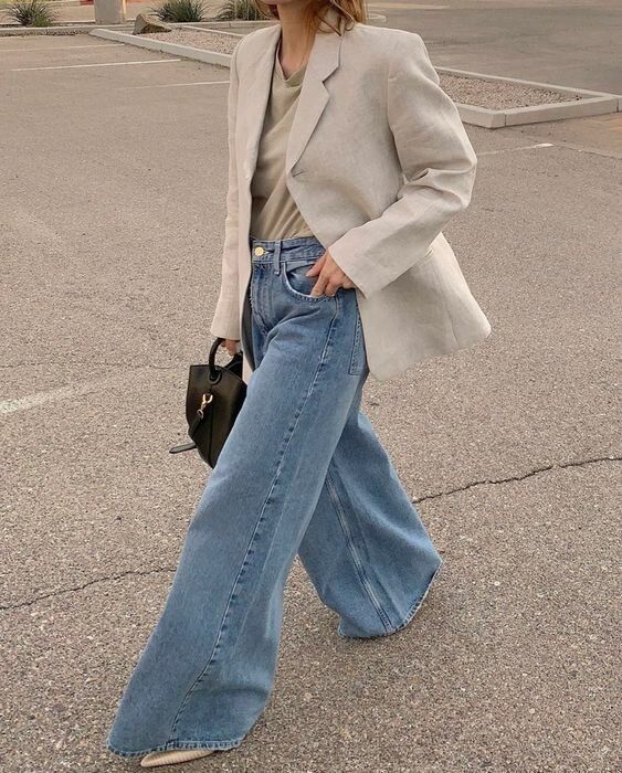a grey t-shirt and an off-white blazer, blue wide leg jeans, nude heels and a black bag for work