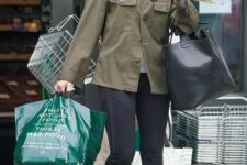 a grey t-shirt, black leggings, a green utility jacket, grey trainers, a black tote for every day