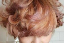 a messy short bob cut with a rose, peach and golden combination is a beautiful and textured idea to rock