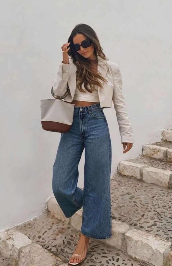 a neutral crop top, a cropped blazer, blue wide leg jeans, nude shoes and a small bag for spring and even summer
